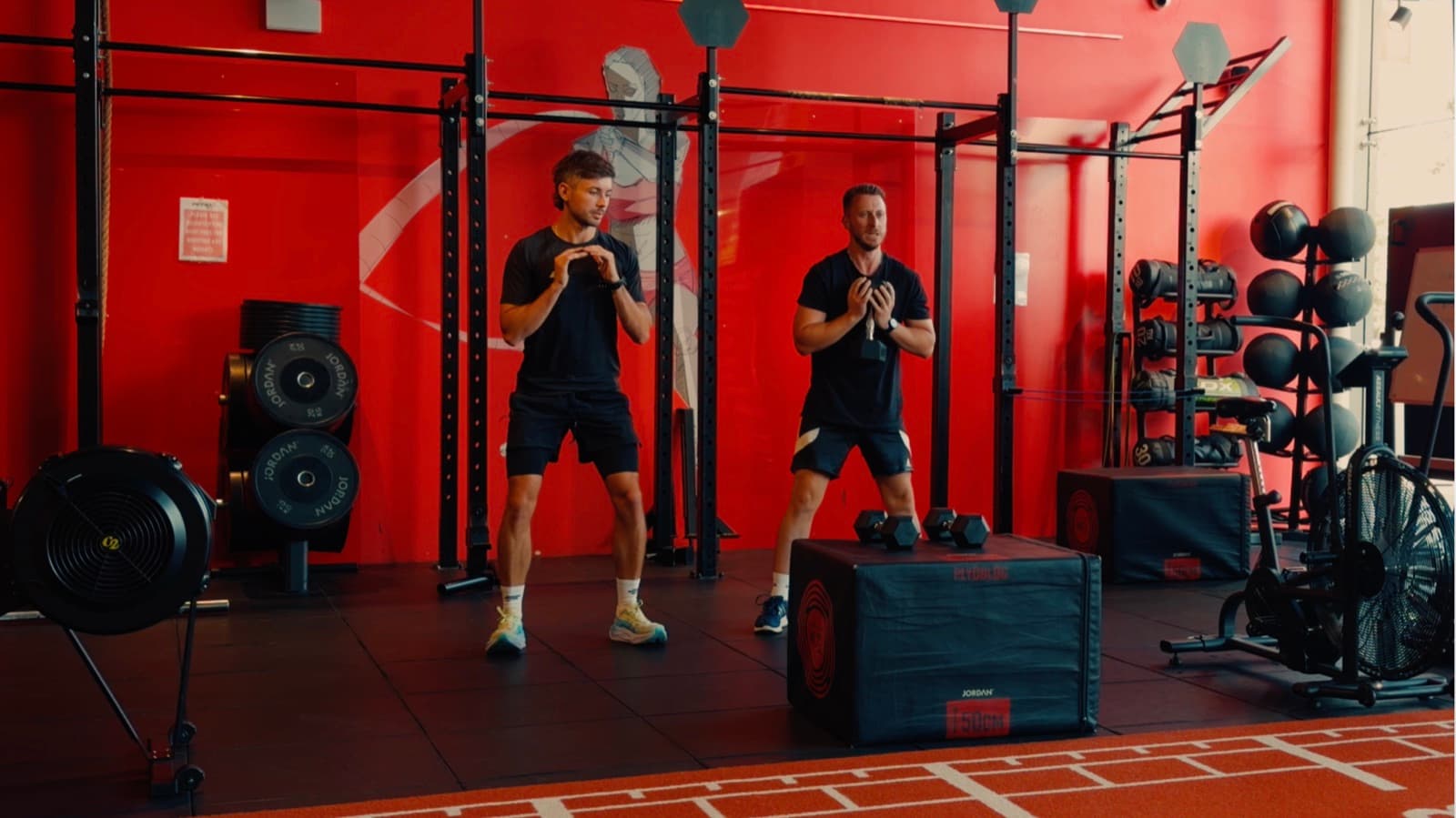 Sam coaching a one-to-one strength session in the gym