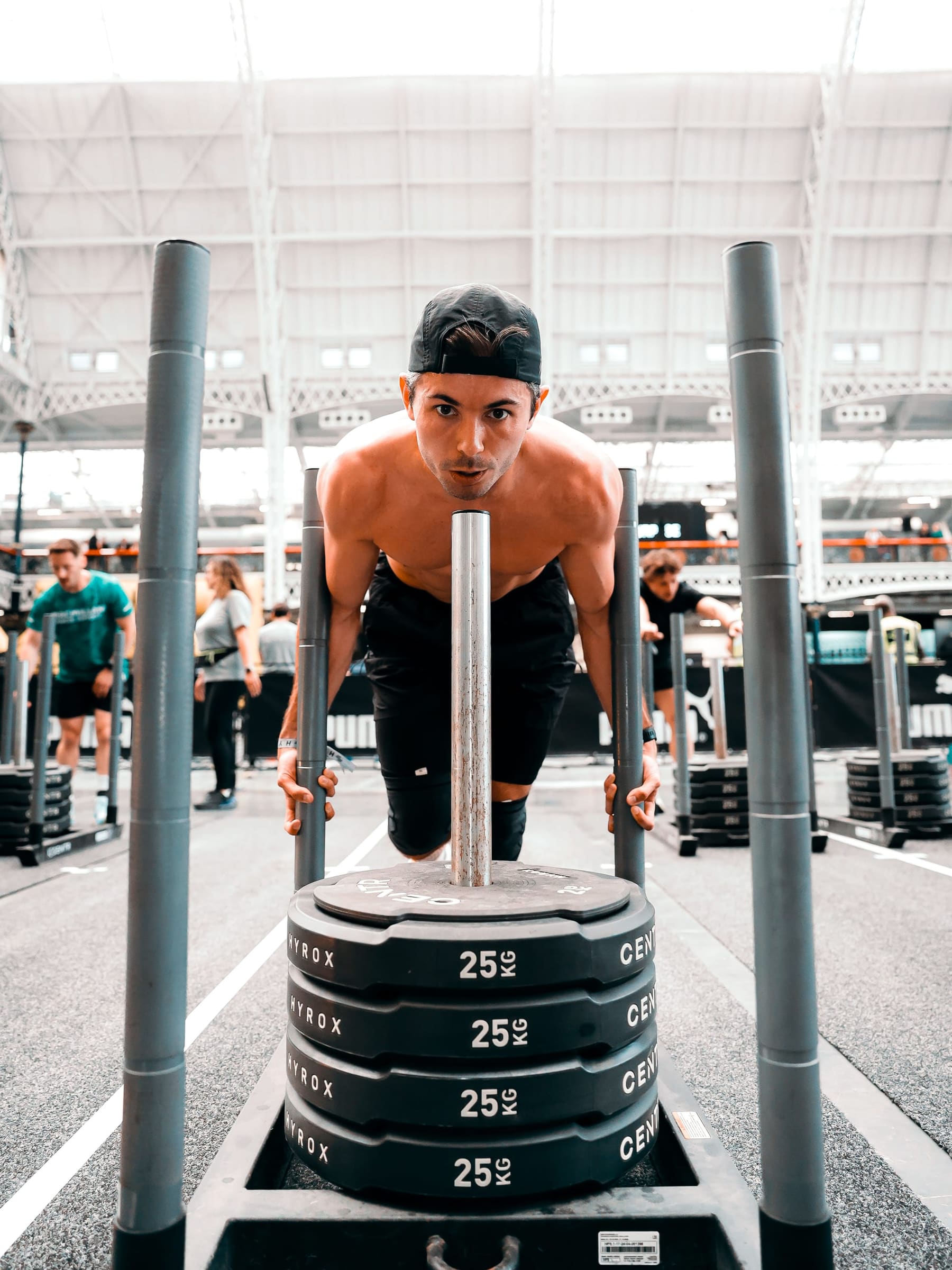 Sam pushing a weighted sled during a Hyrox event