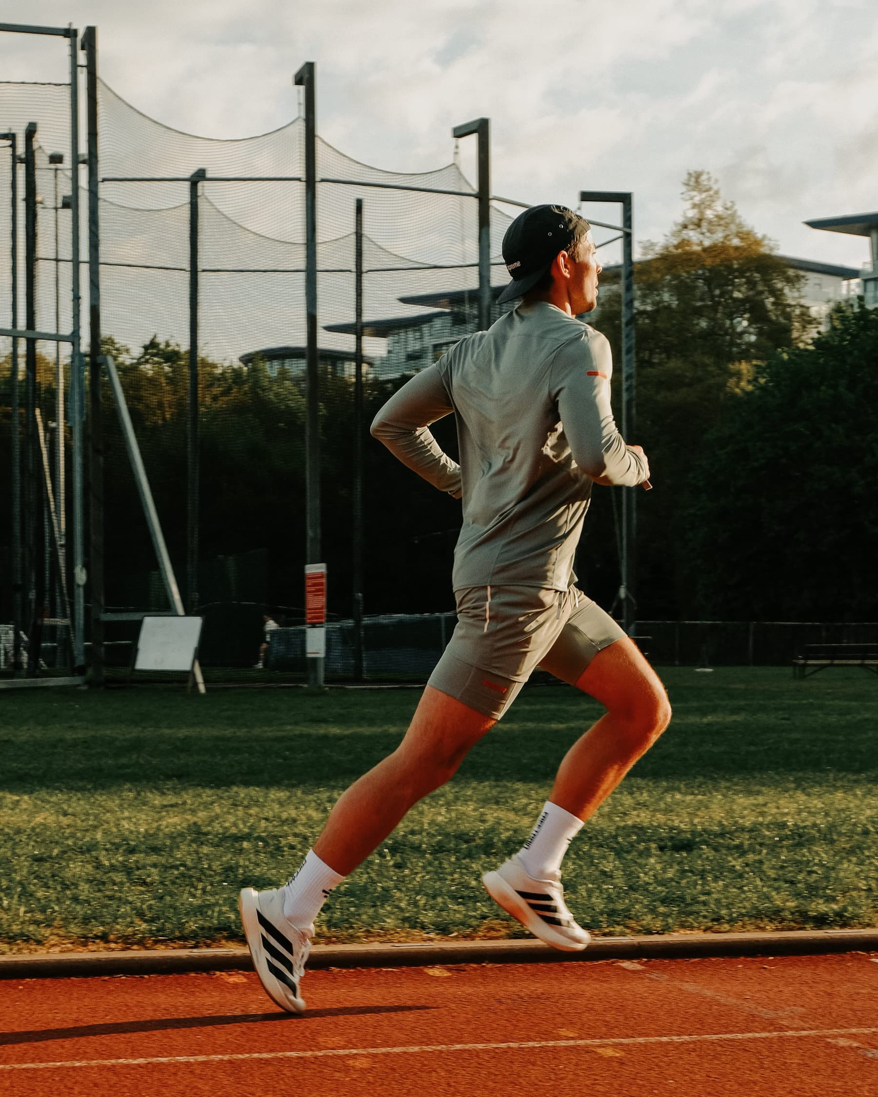 Sam running on a track at sunset