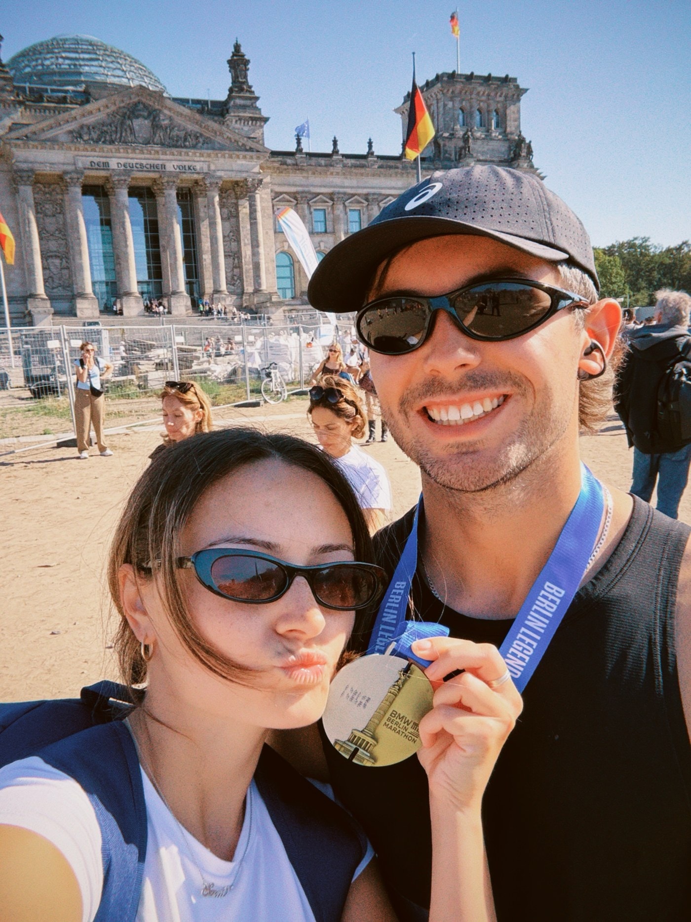 Sam and Emma celebrating after Berlin with his finisher medal