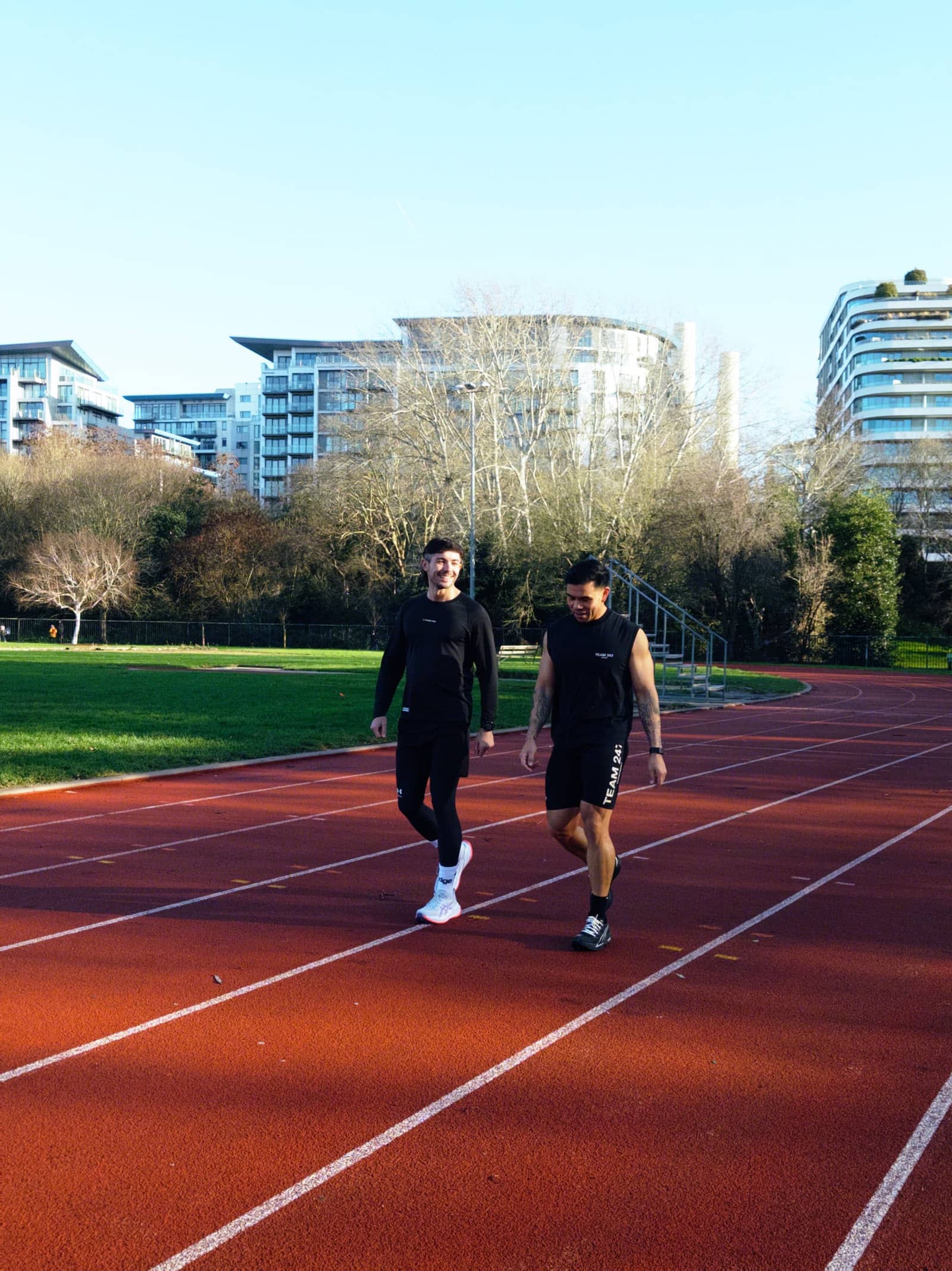Sam Millan coaching a runner on the track